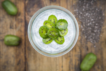 Glass of natural yoghurt with chia seeds and slices of hardy kiwis - LVF05464