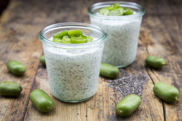 Two glasses of natural yoghurt with chia seeds and slices of hardy kiwis - LVF05465