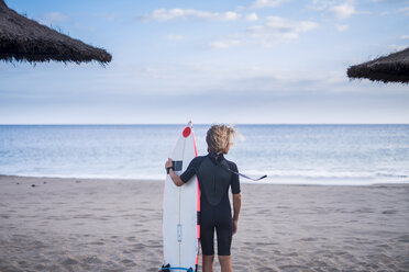 Spain, Tenerife, boy with surfboard on the beach - SIPF00948