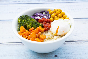 Lunch bowl of quinoa, red cabbage, carrots, roasted chickpeas, broccoli, poached egg and ajvar - LVF05485