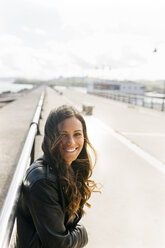 Portrait of happy young woman with long brown hair - MGOF02522