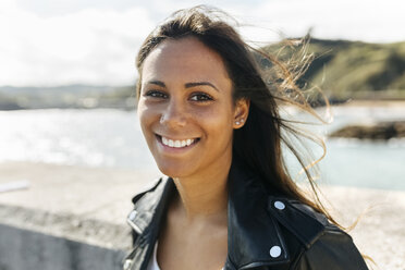 Portrait of happy young woman with long brown hair - MGOF02526