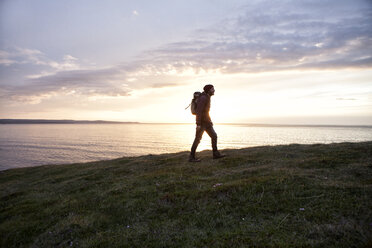 Iceland, man hiking at twilight - RBF05217