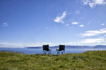 Iceland, two camping chairs on a meadow - RBF05221