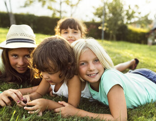 Four little girls playing together on a meadow - MGOF02532