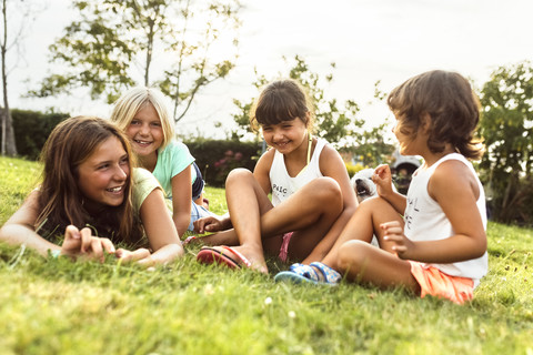 Four girls having fun together on a meadow stock photo