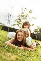 Three girls having fun together on a meadow - MGOF02536