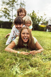 Four girls having fun together on a meadow - MGOF02548