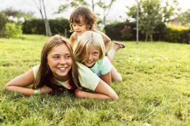 Three girls having fun together on a meadow - MGOF02552