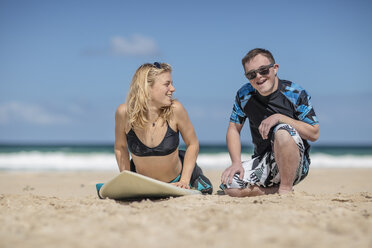 Teenage boy with down syndrome having surf lessons on beach - ZEF10868