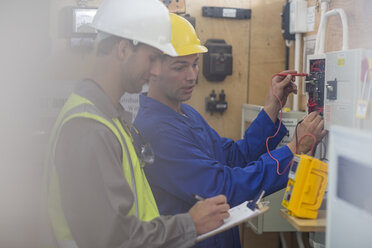 Two electricians working on electrical panel - ZEF10899