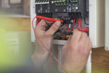 Electrician working on electrical panel - ZEF10900