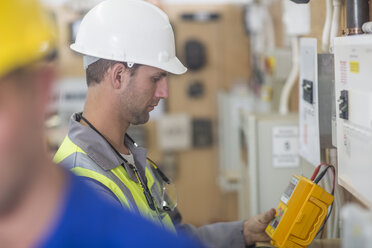 Electrician working with voltmeter - ZEF10902