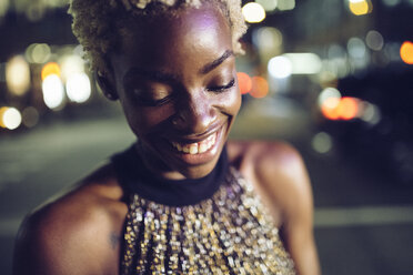 Portrait of happy young woman at night - GIOF01563
