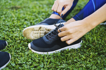 Close-up of sportive woman tying shoes - EBSF01836