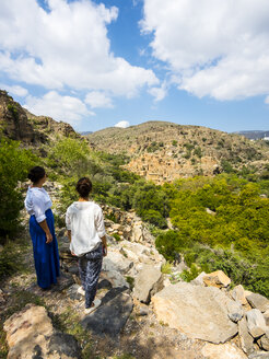 Oman, Jabal Akhdar, Frauen betrachten das verlassene Dorf Wadi Bani Habin - AMF05037