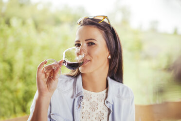 Woman drinking glass of red wine - ZEDF00392