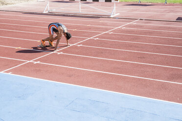 Runner on tartan track in starting position - ABZF01399