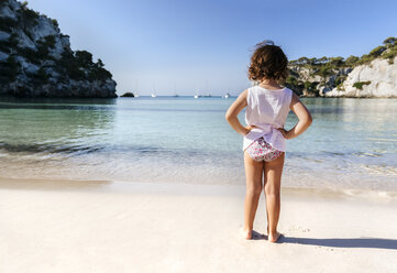 Back view of little girl standing at seafront - MGOF02557