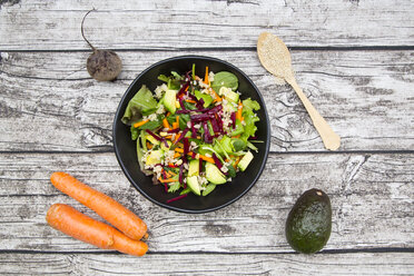 Bowl of autumnal salad with lettuce, carrots, avocado, beetroot, pumpkin and sunflower seeds, pomegranate and quinoa - LVF05494