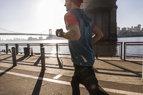 USA, New York City, man running at East River - UUF08813