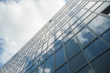 Modern glass facade reflecting clouds - TAMF00719