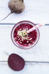 Glass of beetroot smoothie with hemp seed and whole and sliced beetroot - LVF05508