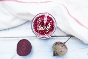 Glass of beetroot smoothie with hemp seed and whole and sliced beetroot - LVF05510