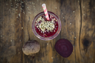 Glass of beetroot smoothie with hemp seed on dark wood - LVF05514