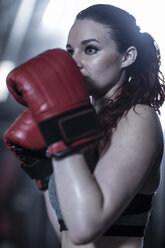 Female boxer practising in gym - ZEF11064