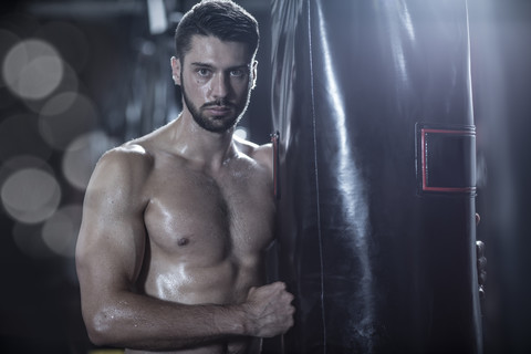 Portrait of boxer at punch bag stock photo