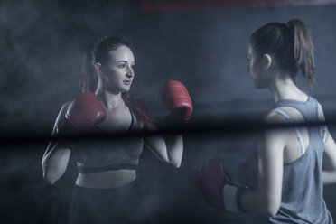 Two female boxers in ring in boxing gym - ZEF11077