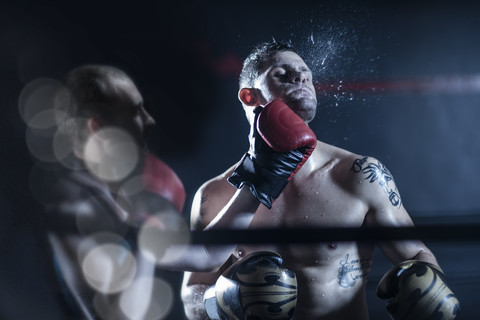 Boxer hitting opponent stock photo