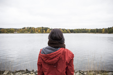 Back view of woman standing at seashore stock photo