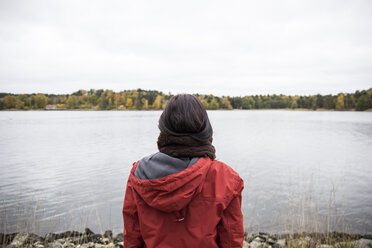 Back view of woman standing at seashore - ABZF01450