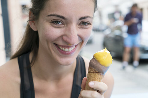 Happy young woman with ice cream cone - TAMF00727