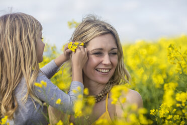 Mother and little daughter together in rape seed field - ZEF11128