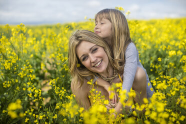 Mother and little daughter together in rape field - ZEF11129