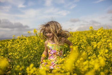 Blond little girl running in rape field - ZEF11132