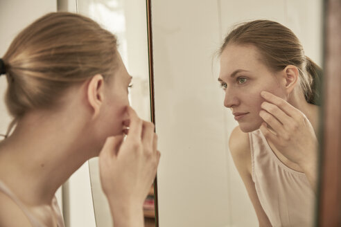 Woman looking in mirror - SUF00084