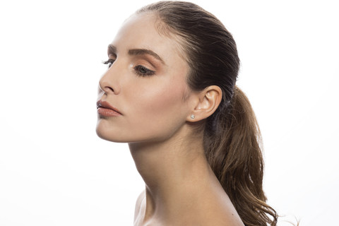 Portrait of bare-chested young woman in front of white background stock photo