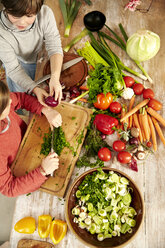 Boy and girl chopping vegetables in the kitchen, top view - TSFF00128