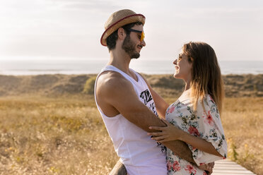 Couple in love face to face near the coast in the evening - MGOF02576