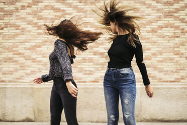 Two women tossing her hair - EBSF01848