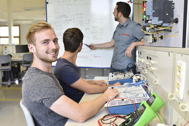 Porträt eines lächelnden Studenten mit einem technischen Lehrer am Whiteboard - LYF00597