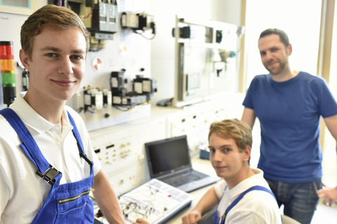 Portrait of smiling students with technical instructor stock photo