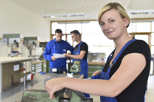 Portrait of smiling female trainee in workshop - LYF00626