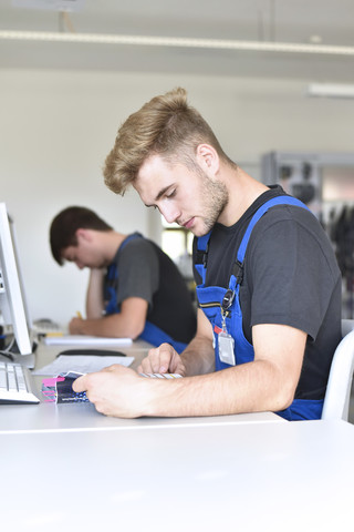 Vocational school students writing a test stock photo