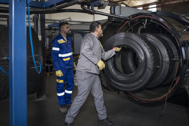 Zwei Reifenreparateure arbeiten in einer Fabrik - ZEF11158