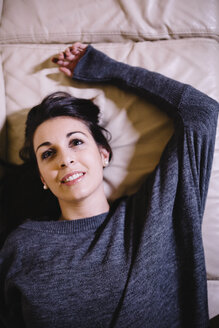 Portrait of woman lying on the couch - JRFF00987